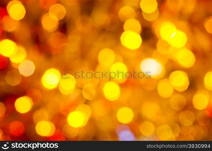 abstract blurred background - brown, yellow and red flickering Christmas lights bokeh of electric garlands on Xmas tree