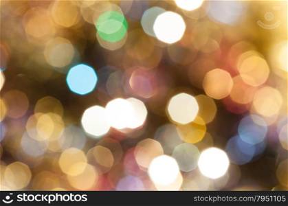 abstract blurred background - colorful brown shimmering Christmas lights of electric garlands on Xmas tree