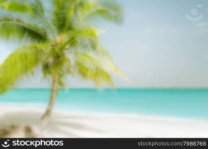 Abstract blurred background for travel concept. Sunny day at amazing tropical beach with palm tree, white sand and turquoise ocean waves. Myanmar (Burma) landscapes and destinations