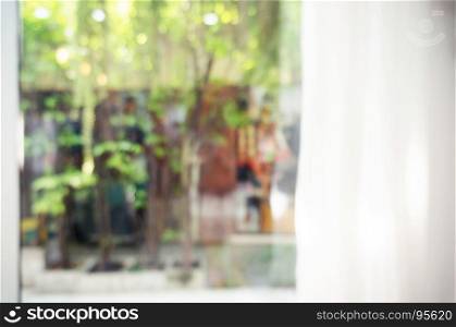 abstract blurred background of curtain with beautiful garden view. can be used for display or background image