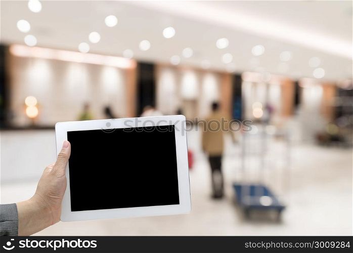 Abstract Blurred background of modern hotel lobby with digital Tablet