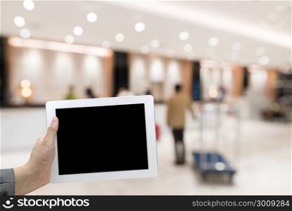 Abstract Blurred background of modern hotel lobby with digital Tablet