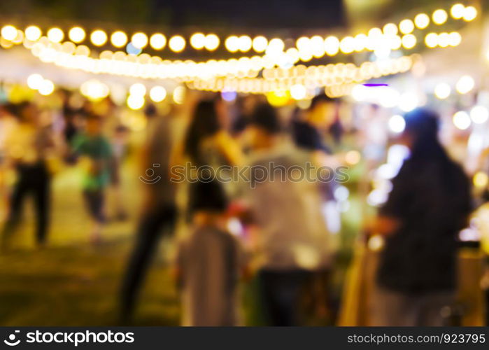 Abstract blurred background of people shopping at night festival