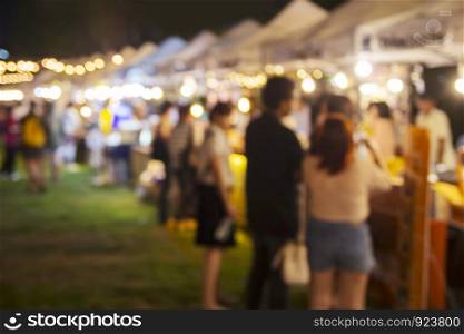 Abstract blurred background of people shopping at night market