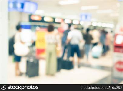 Abstract blurred background of travelers at airport terminal departure check-in with bokeh light