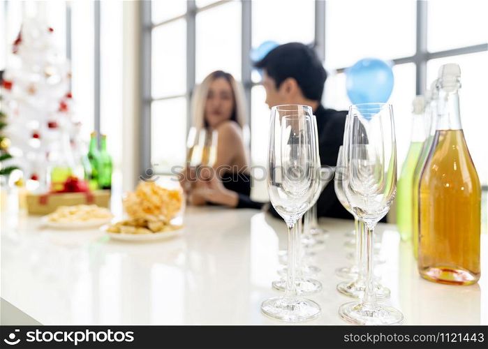 Abstract blurred background of Young asian adult couple celebrating New year christmas holiday with sparkling wine together in living room of big condominium in big city