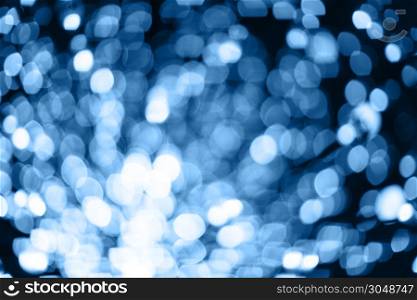 Abstract blurred background with numerous bright festive bokeh in trendy Classic Blue color of the year 2020. Celebration, holidays concept. Horizontal. For lifestyle blog, social media.