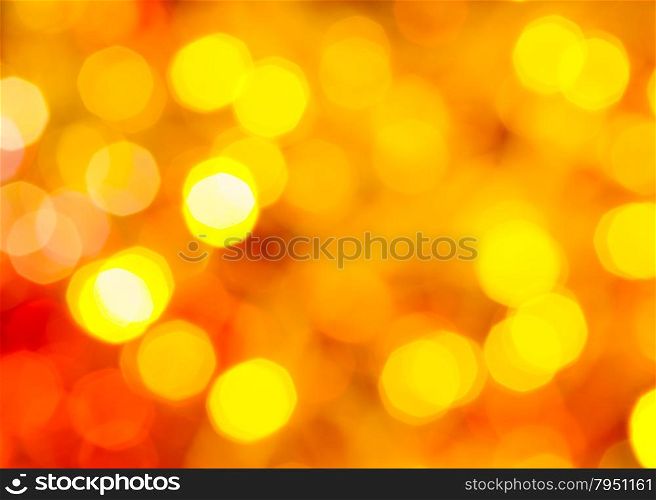 abstract blurred background - yellow and red twinkling Christmas lights of electric garlands on Xmas tree