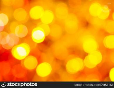 abstract blurred background - yellow and red twinkling Christmas lights of electric garlands on Xmas tree