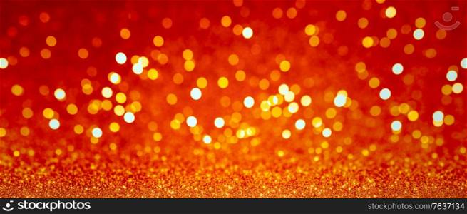 Abstract blurred background, yellow lights on red background. Golden christmas or new year bokeh.. Golden christmas bokeh