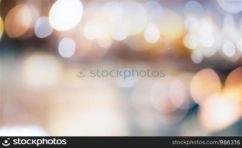Abstract blurred bokeh light with warm tone color background concept.