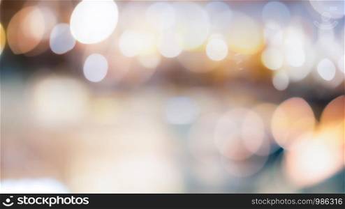 Abstract blurred bokeh light with warm tone color background concept.