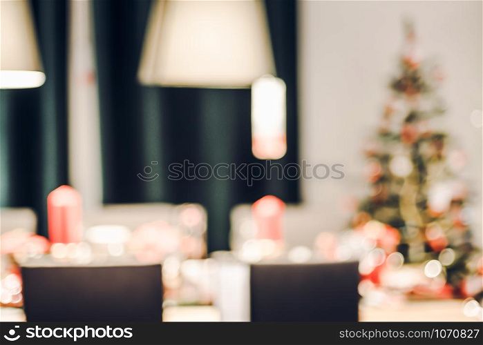 abstract blurred Christmas tree decoration with string light at kitchen in house with bokeh background,winter holiday season celebration festival backdrop.