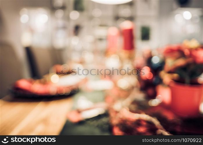 abstract blurred Christmas tree decoration with string light at kitchen table in house with bokeh background,winter holiday season celebration festival backdrop.