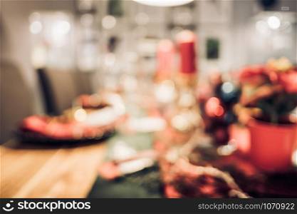 abstract blurred Christmas tree decoration with string light at kitchen table in house with bokeh background,winter holiday season celebration festival backdrop.