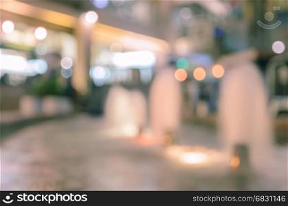 Abstract blurred fountain with shopping mall bokeh lights for background