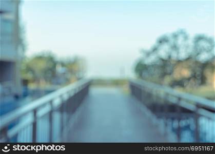 Abstract blurred image of walkway over the outdoor swimming pool for background