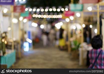 Abstract blurred night market view of empty supermarket aisle, defocused blurry background with bokeh light . street food market concept.