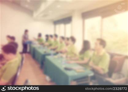 Abstract blurred people in seminar room with vintage effect.