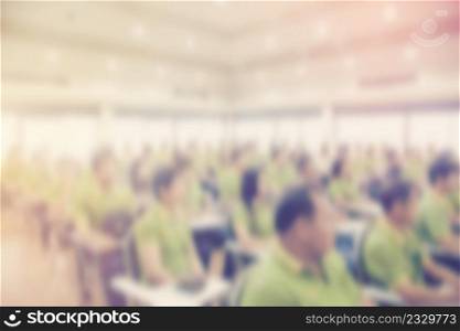 Abstract blurred people in seminar room with vintage effect.