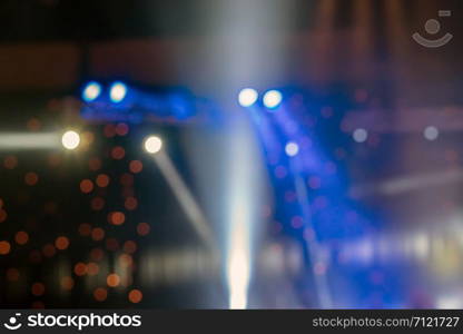 Abstract blurred photo of spotlight in conference hall, seminar and party environment concept