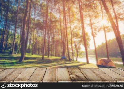 Abstract blurred pine tree and wood table with sunlight vintage