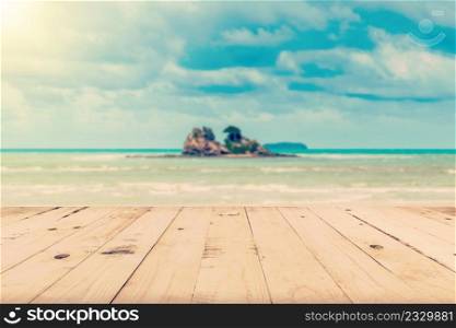 Abstract blurred sea and island with wood table for vintage background.