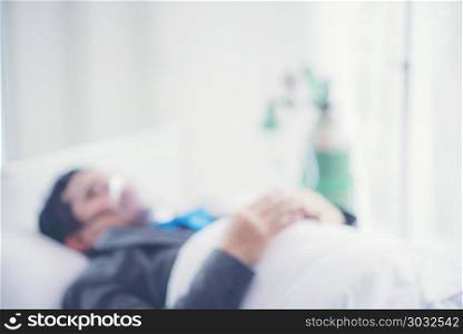 abstract blurry background of Businessman are sick, Working on Hospital Bed, Work Hard Concept