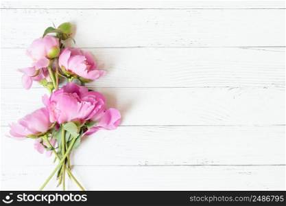Abstract Border of Beautiful pink and white peony flowers on white wooden background with copy space for your text top view and flat lay style.. Abstract Border of Beautiful pink and white peony flowers on white wooden background with copy space for your text top view and flat lay style