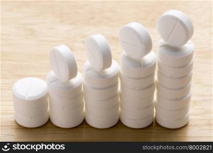 Abstract chart of white pills. Abstract chart of white pills on a gray background
