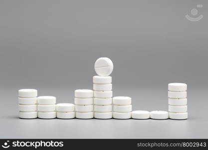 Abstract chart of white pills. Abstract chart of white pills on a gray background