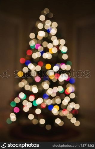 Abstract Christmas tree with blurred multicolored lights.