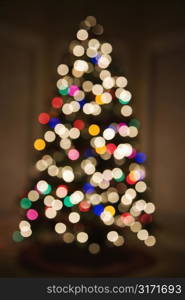 Abstract Christmas tree with blurred multicolored lights.