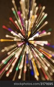 Abstract Christmas tree with motion blurred multicolored lights in radial starburst pattern.