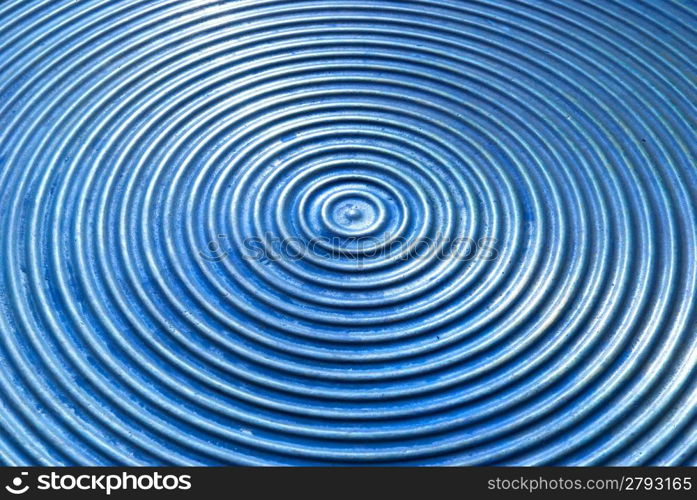 Abstract circle metal plate- blue surface with round lines.