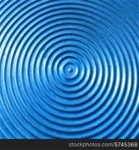 Abstract circle metal plate- blue surface with round lines.