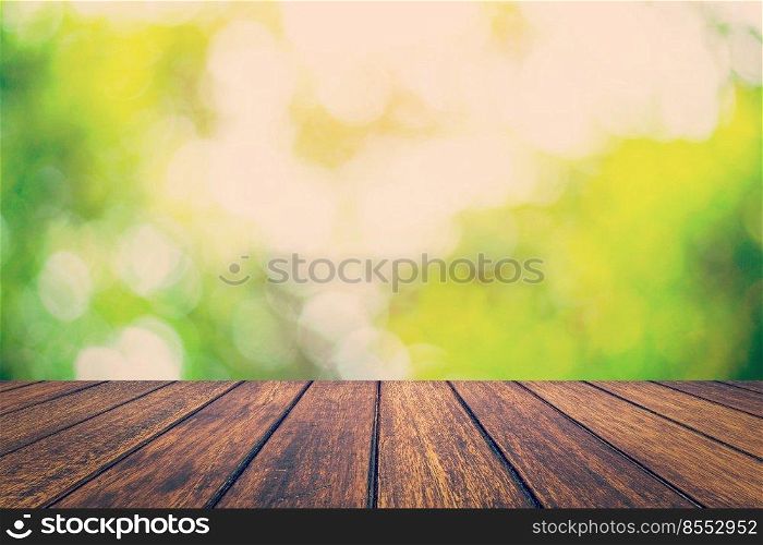 Abstract circular bokeh night and wood table background with space