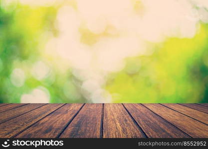 Abstract circular bokeh night and wood table background with space