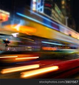Abstract cityscape blurred background. ight view of modern city street with moving transport and illuminated skyscrapers. Hong Kong