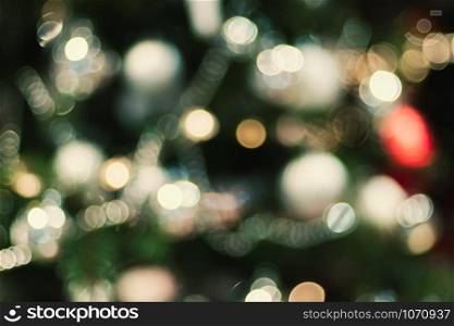 Abstract color blur decoration ball and light string on christmas tree with bokeh light background.winter holiday seasonal