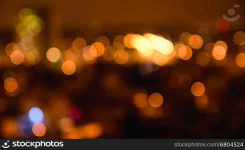 Abstract colorful defocused city lights with bokeh effects at night. Warm tone orange light background.