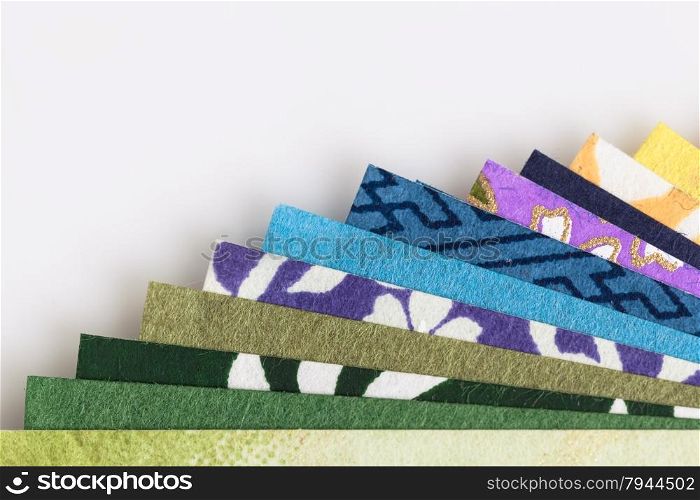 Abstract colorful origami paper pattern texture stacked layer respective, on white background