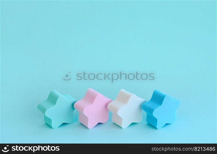 Abstract cosmetic light pastel blue background with small stars of sponges. Template with text space. Abstract cosmetic light blue background with stars of sponges