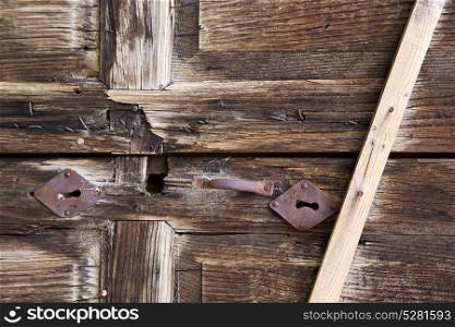 abstract cross brass brown knocker in a closed wood door albizzate varese italy