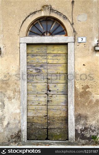 abstract cross brass brown knocker in a closed wood door varese italy azzate