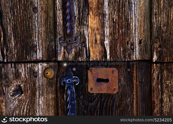 abstract cross brass brown knocker in a closed wood door varese italy mornago