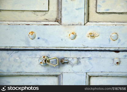 abstract cross brass brown knocker in a closed wood door venegono varese italy