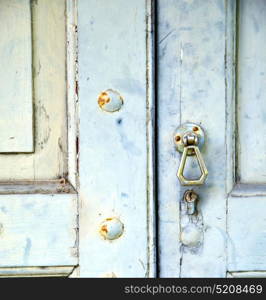 abstract cross brass brown knocker in a closed wood door venegono varese italy