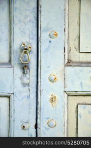 abstract cross brass brown knocker in a closed wood door venegono varese italy