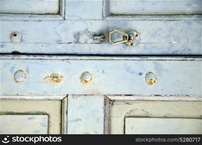 abstract cross brass brown knocker in a closed wood door venegono varese italy